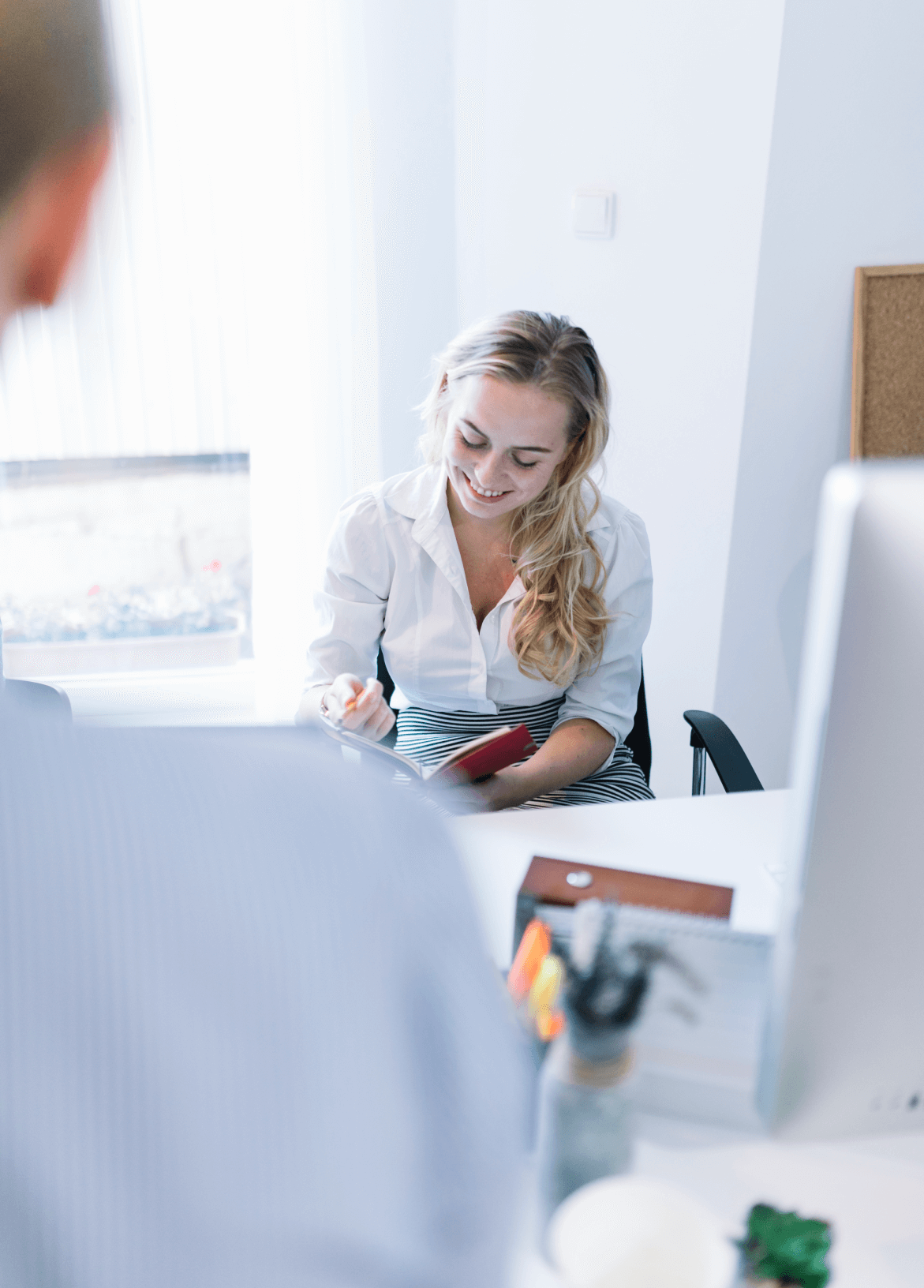 smiling-woman-reading-diary-office-meeting 1 (2) (1)