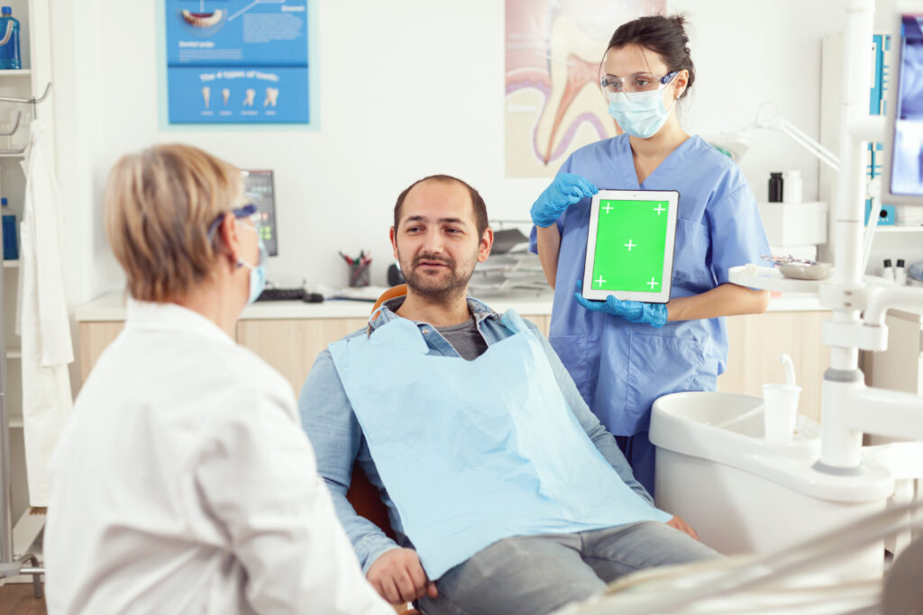 Nurse dentist showing green screen