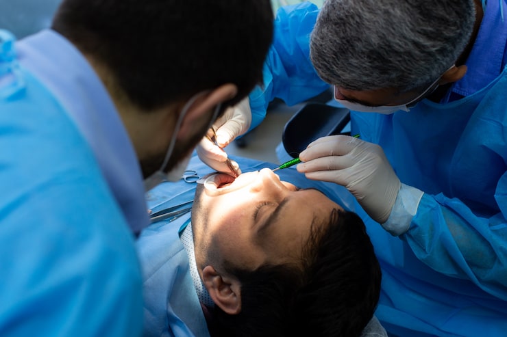 Dental team performing an emergency root canal or extraction procedure on a patient in Waltham